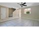 Spacious living room with tile flooring, ceiling fan, staircase, and ample natural light at 4443 Brook Hollow Cir # 19A, Winter Springs, FL 32708