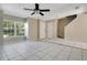 Bright living room featuring tile flooring, ceiling fan, and large windows providing plenty of natural light at 4443 Brook Hollow Cir # 19A, Winter Springs, FL 32708