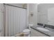 Neutral bathroom featuring a granite-topped vanity, toilet, and shower with a curtain at 565 Ogelthorpe Dr, Davenport, FL 33897