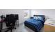 Comfortable bedroom with a bed, desk, and gaming setup, featuring a window for natural light at 565 Ogelthorpe Dr, Davenport, FL 33897