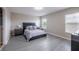 Spacious bedroom with modern furnishings, including a bed, nightstands, and ample natural light from multiple windows at 565 Ogelthorpe Dr, Davenport, FL 33897