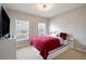 Cozy bedroom with red comforter, white trim, and natural light from two windows at 565 Ogelthorpe Dr, Davenport, FL 33897