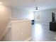 Upstairs bonus room featuring neutral walls, light vinyl flooring, a ceiling fan, and a window at 565 Ogelthorpe Dr, Davenport, FL 33897