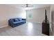 Upstairs bonus room featuring light vinyl flooring, blue futon, TV and media console at 565 Ogelthorpe Dr, Davenport, FL 33897