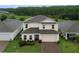 Two-story home with well-manicured lawn and attached two car garage at 565 Ogelthorpe Dr, Davenport, FL 33897