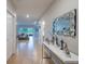 Long hallway leading to the living area featuring tile floors and modern decor at 565 Ogelthorpe Dr, Davenport, FL 33897
