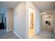 Hallway view showcasing access to a bathroom with a shower and laundry room with modern appliances at 565 Ogelthorpe Dr, Davenport, FL 33897