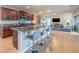 Open concept kitchen with a large island and bar seating, flowing into the living room at 565 Ogelthorpe Dr, Davenport, FL 33897