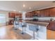 Modern kitchen features stainless appliances, granite countertops and island with bar stool seating at 565 Ogelthorpe Dr, Davenport, FL 33897