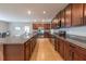 Modern kitchen featuring stainless steel appliances, wood cabinets, and tile flooring at 565 Ogelthorpe Dr, Davenport, FL 33897