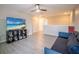 Cozy living room features a modern ceiling fan, TV, and comfortable seating with ample natural light at 565 Ogelthorpe Dr, Davenport, FL 33897