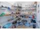 Walk-in pantry with wire shelving, fully stocked with food and supplies at 565 Ogelthorpe Dr, Davenport, FL 33897