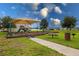 Community playground with a picnic table and grill, perfect for outdoor fun and gatherings at 565 Ogelthorpe Dr, Davenport, FL 33897