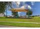 Community playground featuring a large shade cover, slide, and climbing structure at 565 Ogelthorpe Dr, Davenport, FL 33897