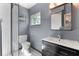 Well-lit bathroom with a sleek black vanity, modern sink, and a glass-enclosed shower with white tile at 600 Sheridan Blvd, Orlando, FL 32804