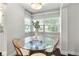 Bright breakfast nook featuring a glass table, comfortable seating, and a large window with a pleasant outdoor view at 600 Sheridan Blvd, Orlando, FL 32804