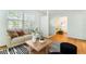 Bright living room featuring hardwood floors, neutral decor, modern furnishings, and an open layout with abundant natural light at 600 Sheridan Blvd, Orlando, FL 32804