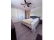 Bedroom with light gray walls, wood laminate flooring, and a view of the closet at 6013 Scotchwood Gln # 20, Orlando, FL 32822