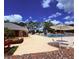 Community pool and clubhouse with ample seating and tables for residents to enjoy at 6013 Scotchwood Gln # 20, Orlando, FL 32822