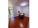Dining room with hardwood floors, contemporary furnishings, and a pass-through window to kitchen at 6013 Scotchwood Gln # 20, Orlando, FL 32822