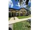 Inviting townhome showcasing a well-maintained lawn and convenient sidewalk access at 6013 Scotchwood Gln # 20, Orlando, FL 32822