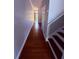 Hallway featuring hardwood floors leading to front entrance at 6013 Scotchwood Gln # 20, Orlando, FL 32822
