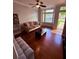 Cozy living room with hardwood floors, a ceiling fan and large windows at 6013 Scotchwood Gln # 20, Orlando, FL 32822