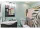 A bathroom features a sink, toilet and shower with decorative curtain at 607 Green Briar Blvd, Altamonte Springs, FL 32714