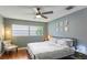Cozy bedroom with a large window, ceiling fan, comfortable bedding and decor at 607 Green Briar Blvd, Altamonte Springs, FL 32714