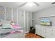 A bedroom features unique owl wallpaper, furniture and wood floors at 607 Green Briar Blvd, Altamonte Springs, FL 32714