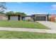 Well-kept single-story home with a lush green lawn and concrete driveway, offering great curb appeal at 607 Green Briar Blvd, Altamonte Springs, FL 32714