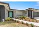 Charming single-story home with a brightly colored front door and meticulously landscaped garden beds at 607 Green Briar Blvd, Altamonte Springs, FL 32714