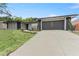 A well-maintained home with a large driveway and manicured lawn provides a welcoming exterior at 607 Green Briar Blvd, Altamonte Springs, FL 32714