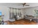 Comfortable living room featuring a couch, ceiling fan and wood floors at 607 Green Briar Blvd, Altamonte Springs, FL 32714