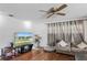 Comfortable living room with a ceiling fan, wood floors, couch and TV at 607 Green Briar Blvd, Altamonte Springs, FL 32714