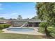 Backyard pool features a slide, lush green grass, complemented by a cozy screened porch area at 607 Green Briar Blvd, Altamonte Springs, FL 32714
