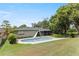 A backyard pool with slide is surrounded by a well-maintained lawn and privacy trees at 607 Green Briar Blvd, Altamonte Springs, FL 32714