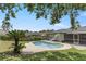 Backyard pool with slide, screened in porch, surrounded by a lush, grassy yard and mature trees at 607 Green Briar Blvd, Altamonte Springs, FL 32714