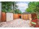 Backyard with storage sheds, a privacy fence, and a brick paver patio at 6430 Yellowstone St, Orlando, FL 32807