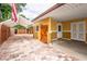 Backyard area with brick driveway, covered tent, shed, and exterior access doors at 6430 Yellowstone St, Orlando, FL 32807