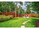 Spacious backyard with a patio, privacy fence, and lush tropical landscaping at 6430 Yellowstone St, Orlando, FL 32807