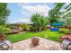 Large backyard featuring a trampoline, swimming pool, fire pit and brick patio at 6430 Yellowstone St, Orlando, FL 32807