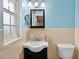 Cozy bathroom features a sleek black vanity and is illuminated by attractive sconce lighting at 6430 Yellowstone St, Orlando, FL 32807