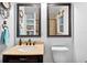 Modern bathroom with dual mirrors, a vanity with a stone countertop, and a toilet with a stylish design at 6430 Yellowstone St, Orlando, FL 32807