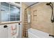 Bathroom showcasing a tiled shower-tub combination with decorative accents and neutral colored walls at 6430 Yellowstone St, Orlando, FL 32807