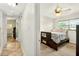 Bright bedroom with hardwood floors featuring a large window and an ensuite bath at 6430 Yellowstone St, Orlando, FL 32807