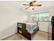Bright bedroom with hardwood floors, a large window, and a ceiling fan for added comfort at 6430 Yellowstone St, Orlando, FL 32807