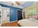 Comfortable bedroom with hardwood floors, blue accent wall, and access to a hallway and closet at 6430 Yellowstone St, Orlando, FL 32807