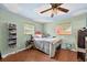 Cozy bedroom featuring a cloud-painted ceiling, hardwood floors, and natural light from two windows at 6430 Yellowstone St, Orlando, FL 32807