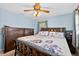 This cozy bedroom features a ceiling fan, a neutral wall color, and classic wood furniture at 6430 Yellowstone St, Orlando, FL 32807